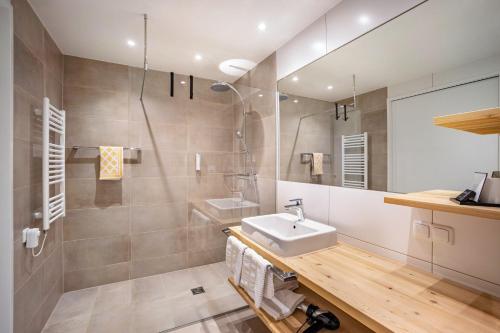 a bathroom with a sink and a mirror at Stoana Apt 2-3 in San Giacomo