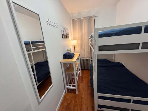 a room with two bunk beds and a mirror at Room in Chelsea 2 with Kitchen - Shared Bathroom -5th Floor Walk-UP in New York