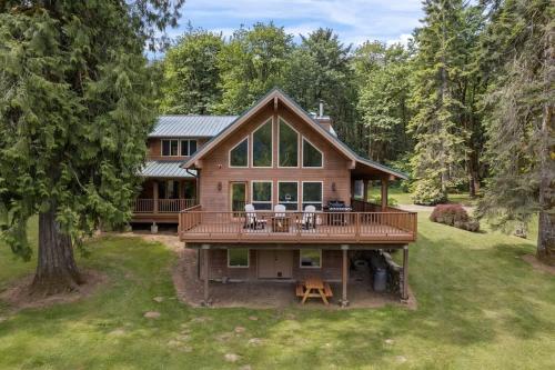 an aerial view of a house with a large deck at Iron Mountain - Spacious Secluded Lodge with Hot Tub & Game Room in Sandy