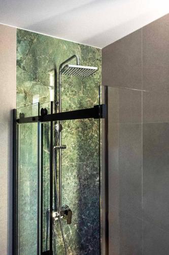 a shower with a glass door in a bathroom at Dream House Banja Luka in Banja Luka