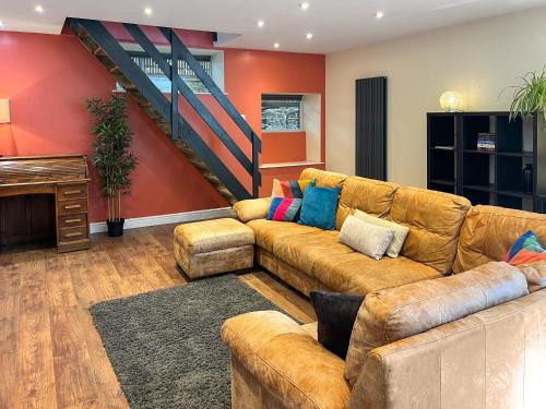 a living room with a couch and a piano at Home Farm - The Dairy -Uk34626 in Dunragit