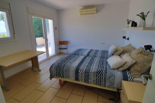 a bedroom with a bed and a table and a desk at Luxurious villa in the sun in Mijas Costa