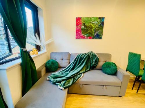 a living room with a couch with a blanket on it at Shoreditch Dream in London