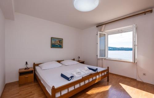 a bedroom with a bed and a large window at Beach house Lozica by Villas Guide in Dubrovnik