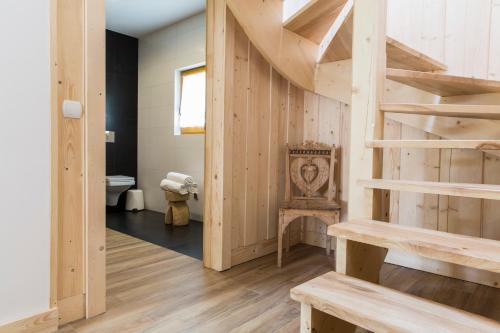 a wooden staircase in a room with a toilet at Domek Babcynówka in Zakopane