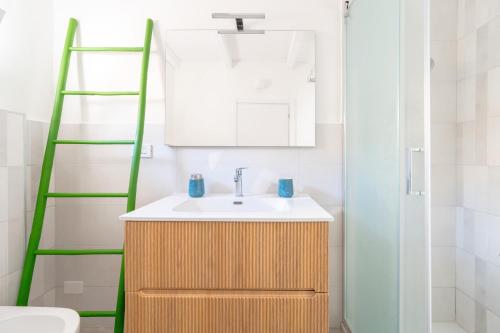 a bathroom with a sink and a green ladder at Dimora Bianca in San Cesario di Lecce