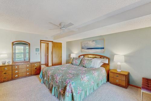 a bedroom with a bed and a ceiling fan at Whispering Breeze Condo in Laguna Beach