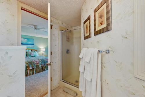 a bathroom with a shower and a bed at Whispering Breeze Condo in Laguna Beach