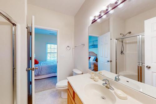 a bathroom with a sink and a toilet and a mirror at Captiva Sands at Eagles Landing --- 4500 Sand Piper Drive #4514 in Bald Eagle Village