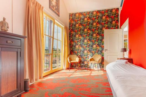 a bedroom with a bed and a floral wallpaper at Beautiful house in nature for 20 people in Wetering