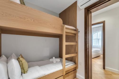 a bedroom with a bunk bed and a mirror at Riviera Family Suite in Khor Fakkan