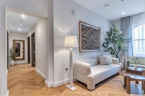 a living room with a couch and a table at Riviera Family Suite in Khor Fakkan