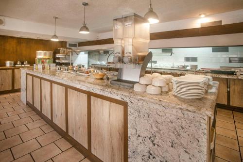 a kitchen with a counter with plates and dishes at Quality Inn Ciudad Obregon in Ciudad Obregón