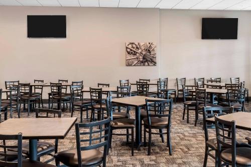 an empty room with tables and chairs in it at Copper King Convention Center, an Ascend Collection Hotel in Butte