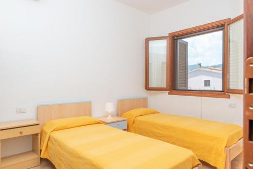 Ένα ή περισσότερα κρεβάτια σε δωμάτιο στο Villetta Olivastro