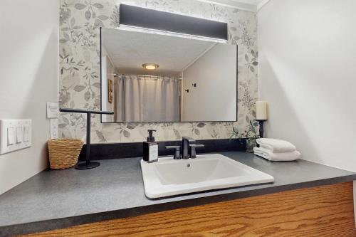 a bathroom with a white sink and a mirror at The Glen C10 in Sugar Mountain