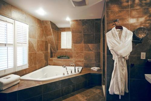 a bathroom with a bath tub and a sink at The Peacock Inn, an Ascend Collection Hotel in Princeton