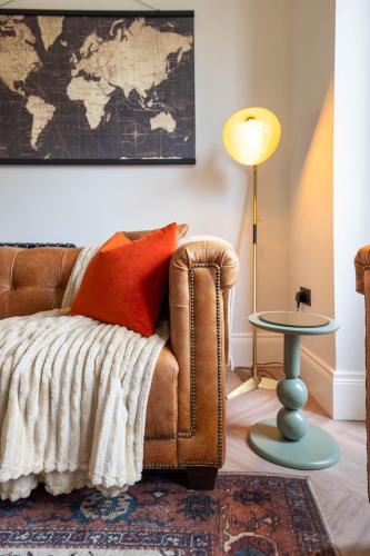 a living room with a couch and a map on the wall at Battersea Boutique Apartment 1 in Bangor