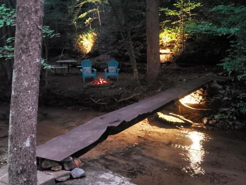 two chairs and a fire in the woods at night at The Loft at Old Falls in Primm Springs