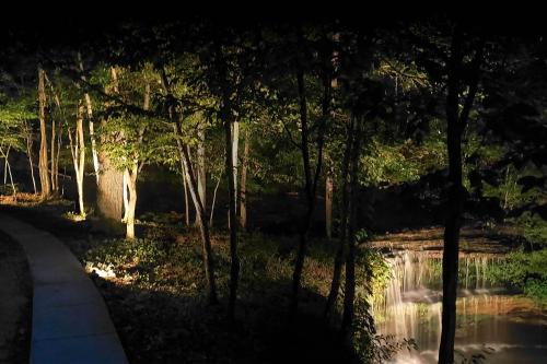 a park with a pond and trees and a path at The Loft at Old Falls in Primm Springs