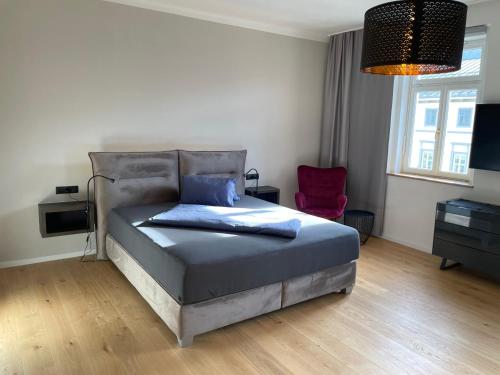 a bedroom with a bed with a blue pillow on it at Gh Alte Post - Top 8 Kapitän in Gmünd in Kärnten