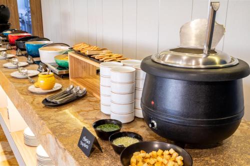 a buffet line with food on a table at Sonesta Hotel Ibagué in Ibagué