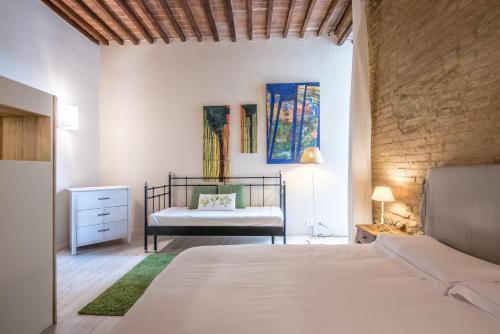 a bedroom with a bed and a dresser at Radicondoli Studio in Radicondoli