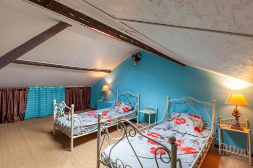 Dos camas en una habitación con una pared azul. en Villa Sam Suffy - 10 personnes, en La Seyne-sur-Mer