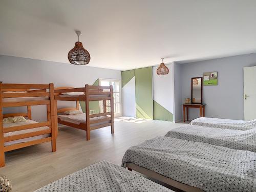 a bedroom with two bunk beds and two beds at Les Caboches de Garanche in Charentay