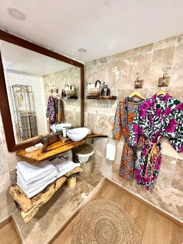 a bathroom with a sink and a mirror at Casa Pombo SXM in Anse Marcel 