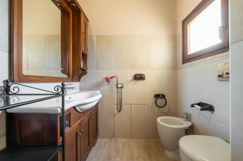 a bathroom with a sink and a toilet at Il Nido di Mennenne in Villasimius