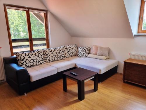 ein Wohnzimmer mit Couch und Tisch in der Unterkunft Apartment Rogla Residence in Vitanje