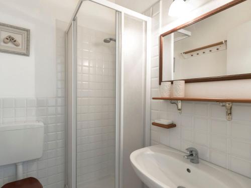 a white bathroom with a shower and a sink at Apartment Tenuta Naiano Leonardo in Cavaion Veronese