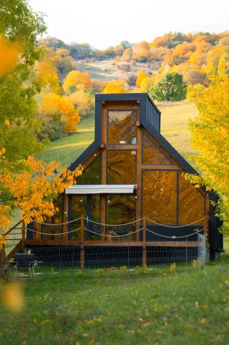 a gazebo in the middle of a field at Luna by NorAtlas Heritage in Varlămul