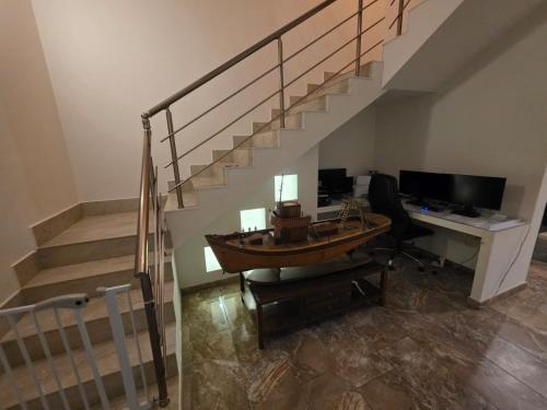 an office with a desk and a desk with a boat on it at Best In Town in Qormi