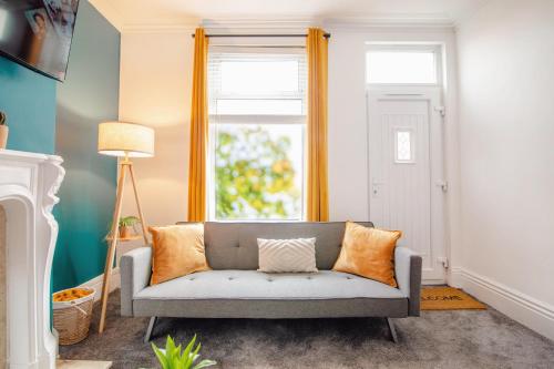a living room with a couch and a window at Blue Lagoon Retreat Escape Free Parking 14ppl in Sheffield