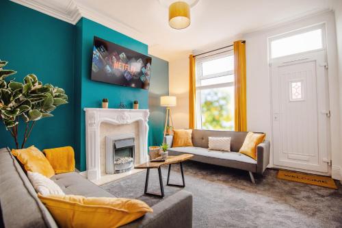 a living room with a couch and a fireplace at Blue Lagoon Retreat Escape Free Parking 14ppl in Sheffield