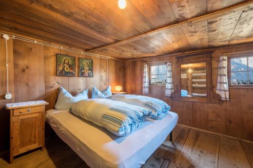 a bedroom with a bed in a wooden room at Untervernatsch Fewo Ötzi in Senales