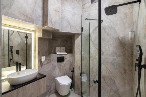 a bathroom with a toilet and a sink and a shower at Royal jacuzzi apartment on Krehivska 10 st in Lviv