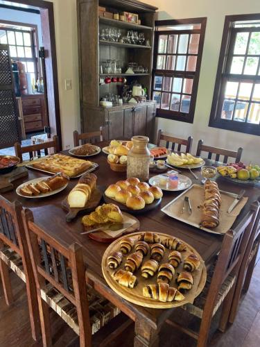 a table with many plates of food on it at Estalagem Angu Duro in São Gonçalo do Rio das Pedras
