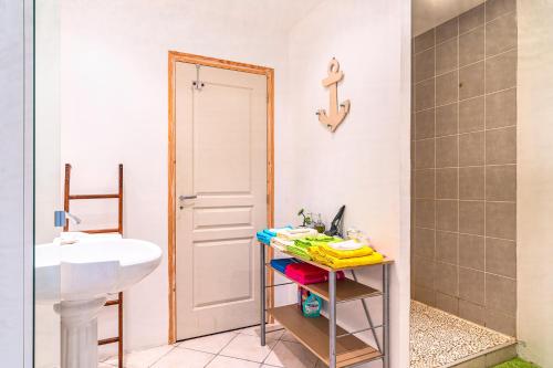 a bathroom with a sink and a toilet and a mirror at Logement T3, Dune du Pilat à 5 km in La Teste-de-Buch