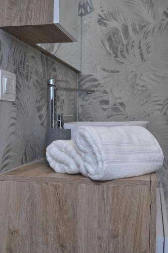 a bathroom with a sink and towels on a counter at La Terrazza di Luca B&B in Tavernelle