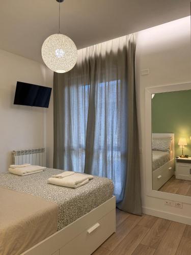 a bedroom with a bed and a large mirror at La Terrazza di Luca B&B in Tavernelle