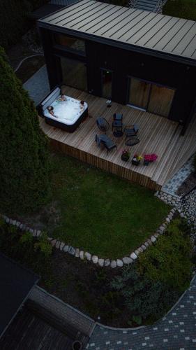 an aerial view of a deck with chairs and a fountain at Villa Lakstīgalas Lux in Skrīveri