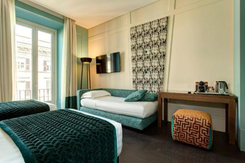 a hotel room with two beds and a window at Mascagni Luxury Rooms & Suites in Rome