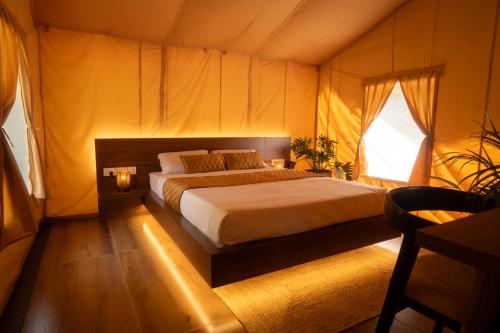 a bedroom with a bed in a tent at Vanantara - Riverside Eco Retreat in Ernakulam