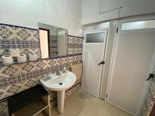 a bathroom with a sink and a mirror at Red Carpet Surf Camp , Surf , Chill & Ocean Views in Tamraght in Tamraght Ouzdar