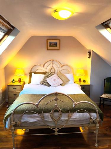 a bedroom with a large bed in a attic at Castle View Suite - Corvesgate Cottage - 3 room suite in Corfe Castle