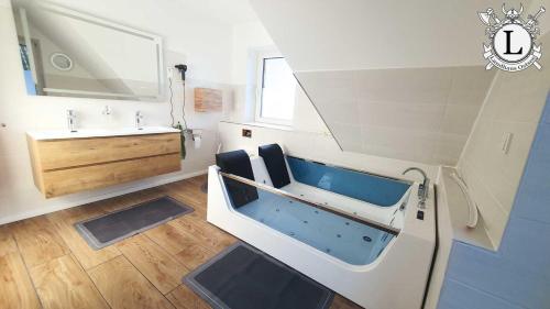 a bathroom with a sink and a bath tub at Landhaus Ferien Ostsee in Sterup