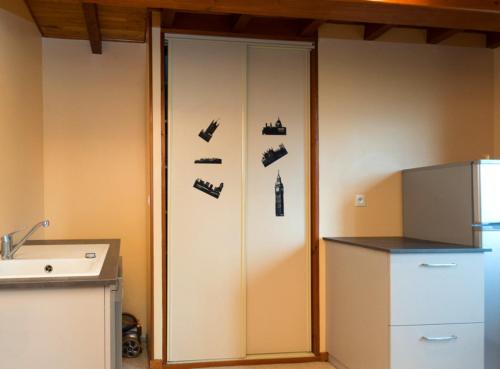 a kitchen with a cabinet with shoes on it at Gîte Télégraphe, Sonnay in Sonnay